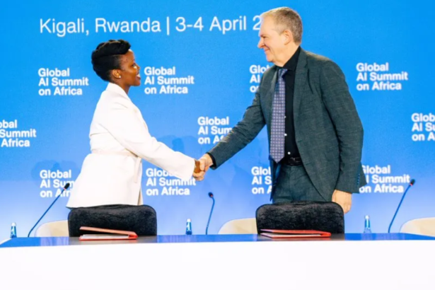 Rwanda Minister of ICT and Innovation, Hon. Paula M. Ingabire and Dr. Trevor Mundel, President of Global Health at the Gates Foundation shake hands after signing an MoU for the establishment of the Rwanda AI Scaling Hub during the inaugural Global AI Summit on Africa, in Kigali, Rwanda,